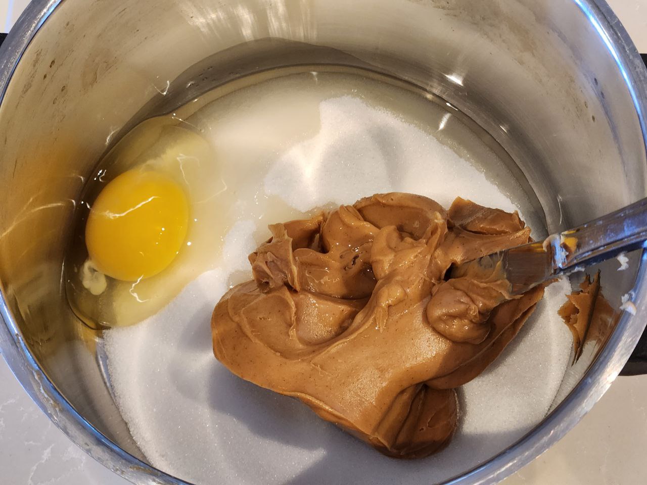 sugar, one egg, and peanut butter in a metal pot