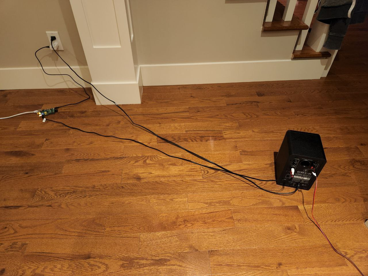 a speaker connected to a circuit board on my hardwood floor